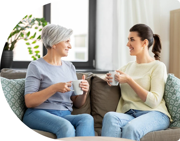 Two women drinking tea and smiling