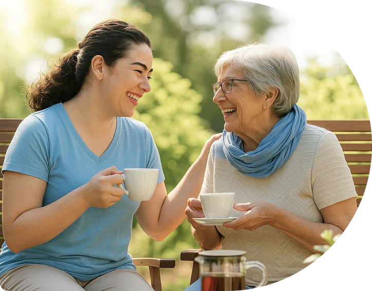 Two women drinking tea and smiling
